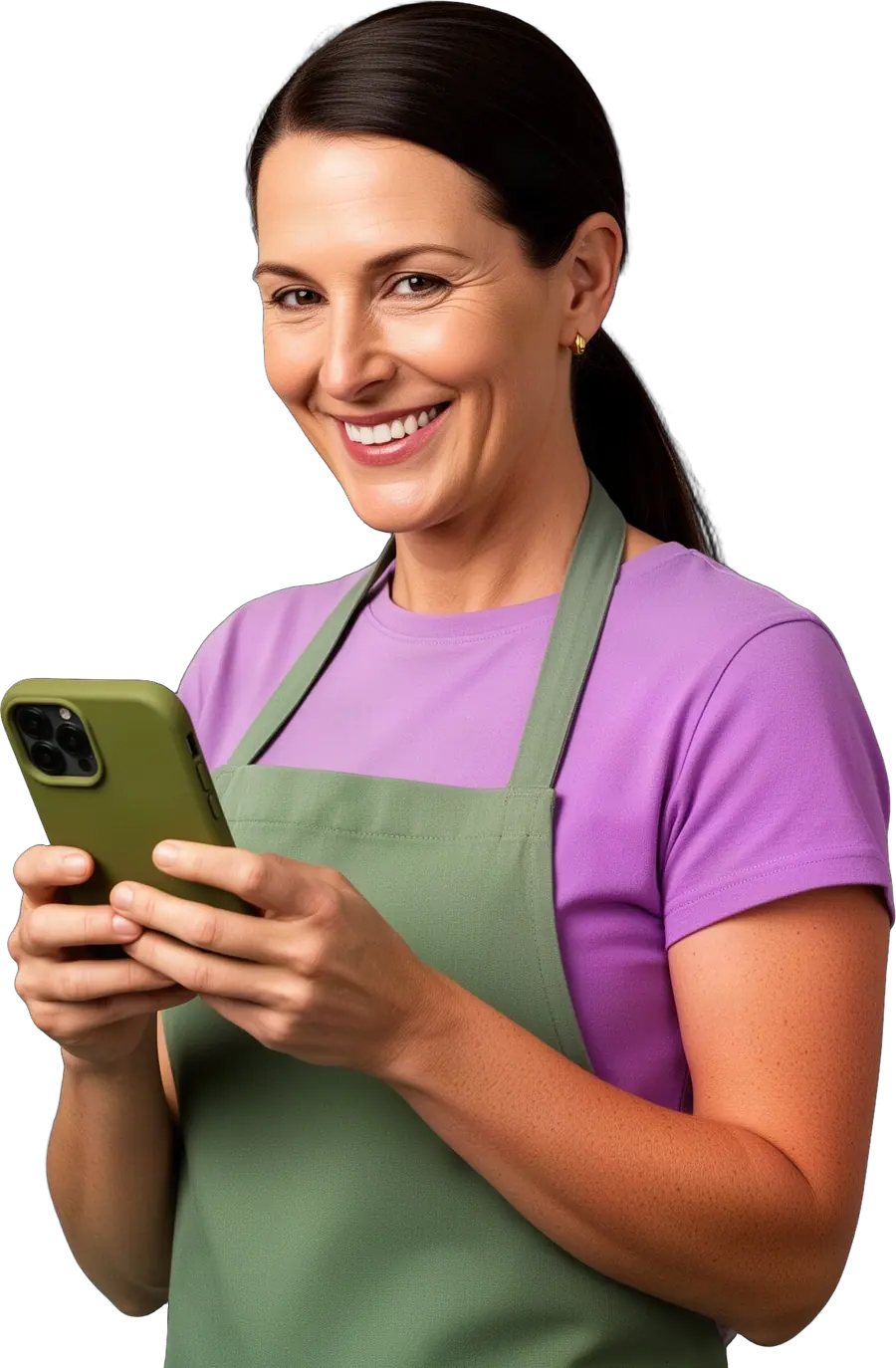 A smiling woman with a dark ponytail in a lilac t-shirt and sage apron holding an olive-cased smartphone.